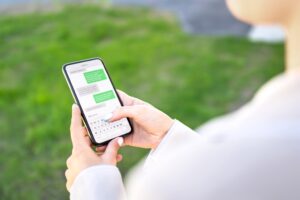 Person using their mobile phone to send a text message.